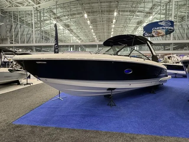 Slide: The Image of 2024 Chaparral 307 SSX boat displayed indoors on blue carpet. - 5