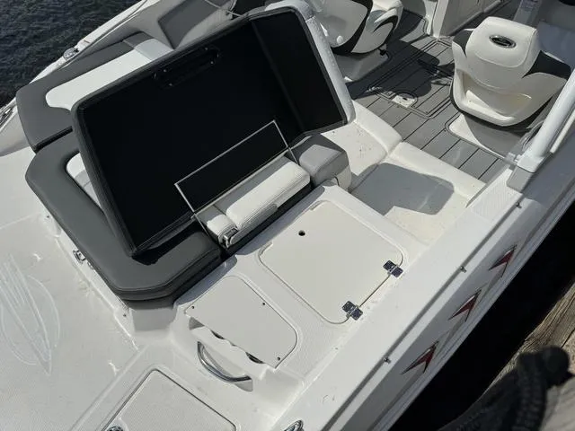 Slide: The Image of 2024 Chaparral 21 SSi boat interior with open storage compartment and seating. - 10