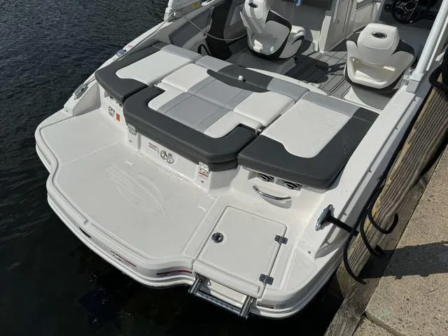 Slide: The Image of 2024 Chaparral 21 SSi boat with spacious seating, docked by the water. - 3