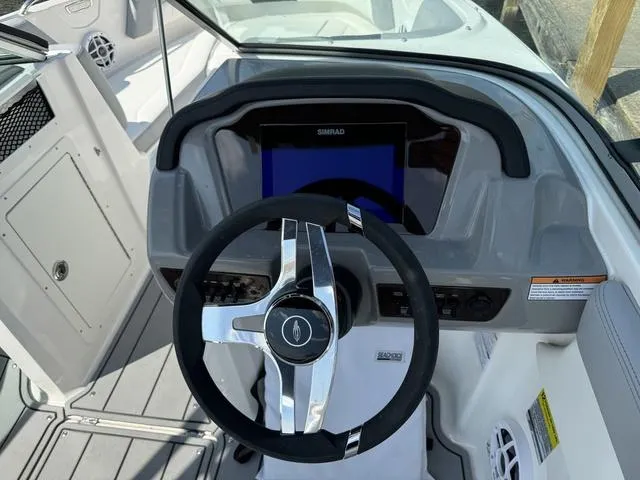 Slide: The Image of 2024 Chaparral 21 SSi boat dashboard with steering wheel and digital display. - 7