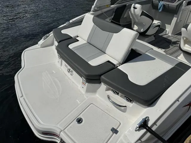 Slide: The Image of 2024 Chaparral 21 SSi boat with sleek seating and modern design on the water. - 9