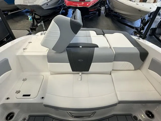 Slide: The Image of 2024 Chaparral 21 SSi boat interior with gray and white seating arrangement. - 12