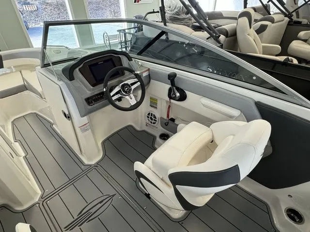Slide: The Image of 2024 Chaparral 21 SSi boat interior with modern dashboard and comfortable seating. - 16