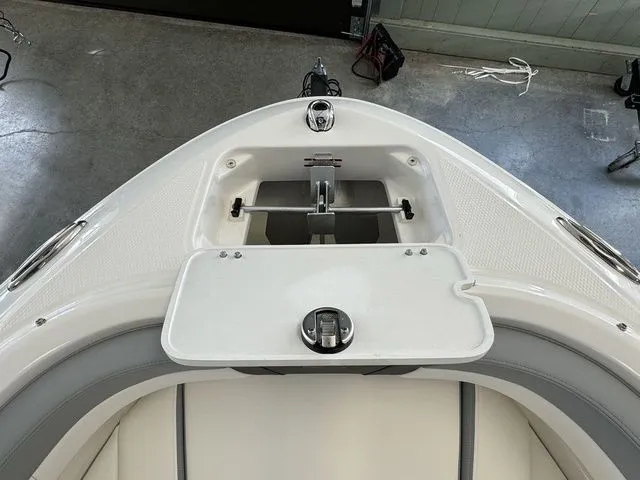 Slide: The Image of 2024 Chaparral 21 SSi boat bow with anchor storage compartment open. - 21