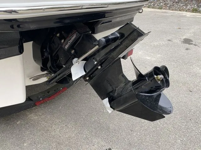 Slide: The Image of 2024 Chaparral 21 SSi boat with MerCruiser outdrive on pavement. - 4