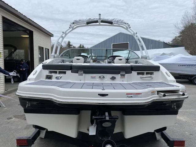 Slide: The Image of 2024 Chaparral 21 SSi boat, rear view, parked outdoors near a building. - 5