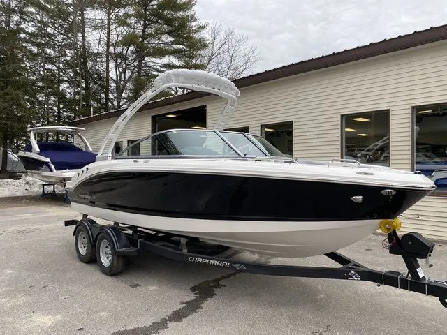 Slide: The Image of 2024 Chaparral 21 SSi boat on trailer, parked outside a building. - 8