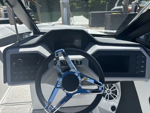 Slide: The Image of 2024 Cobalt CS22 boat dashboard with sleek steering wheel and modern controls. - 5