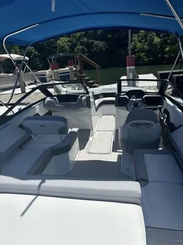 Slide: The Image of 2024 Cobalt CS22 boat interior with seating, steering wheel, and blue canopy. - 7