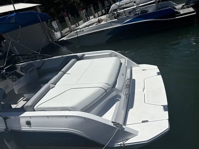 Slide: The Image of 2024 Cobalt CS22 boat with sleek design, docked in a marina. - 8