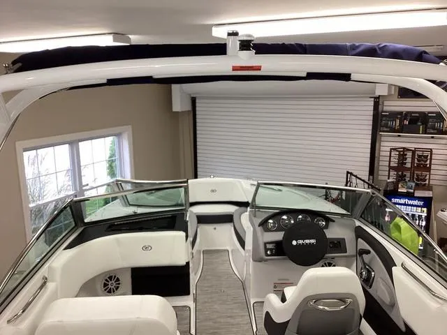 Slide: The Image of 2024 Cobalt 220S boat interior with sleek design and modern dashboard in showroom. - 10