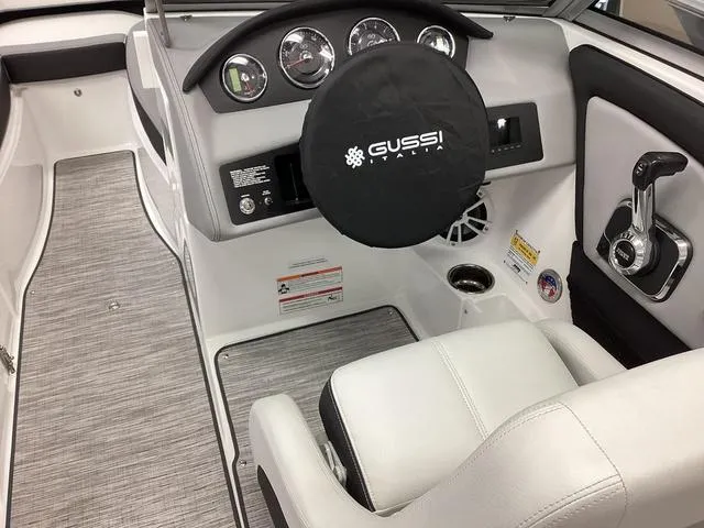 Slide: The Image of 2024 Cobalt 220S boat interior with Gussi Italia steering wheel and modern dashboard controls. - 13