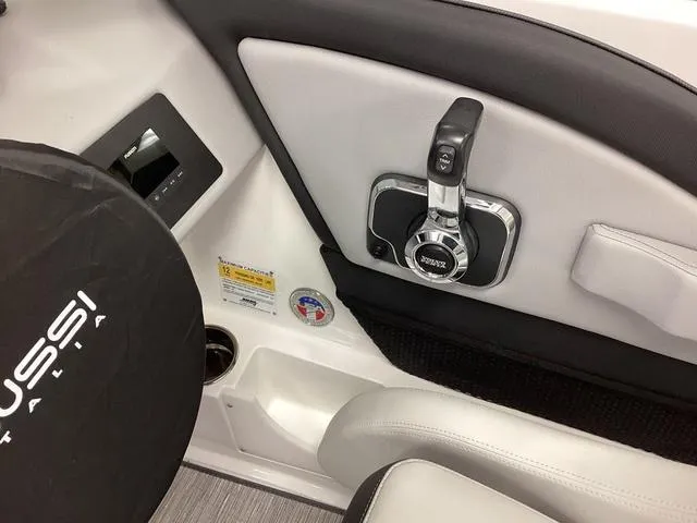 Slide: The Image of Interior of 2024 Cobalt 220S boat featuring control panel and steering wheel. - 14