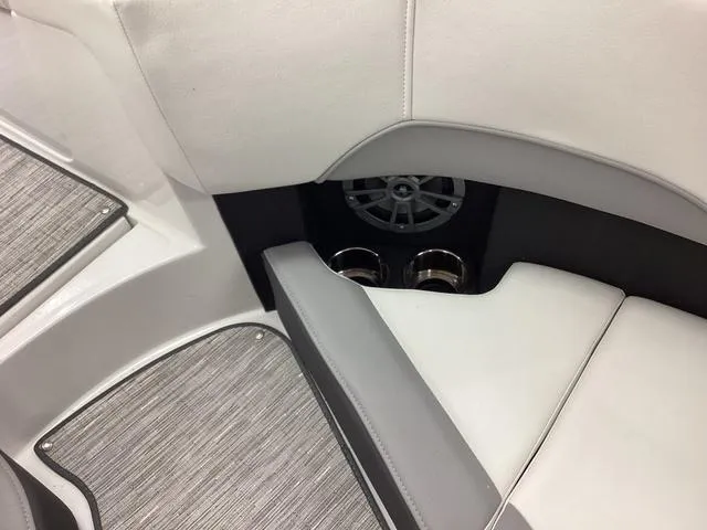 Slide: The Image of 2024 Cobalt 220S boat interior with cup holders and speaker, featuring sleek white and gray design. - 15