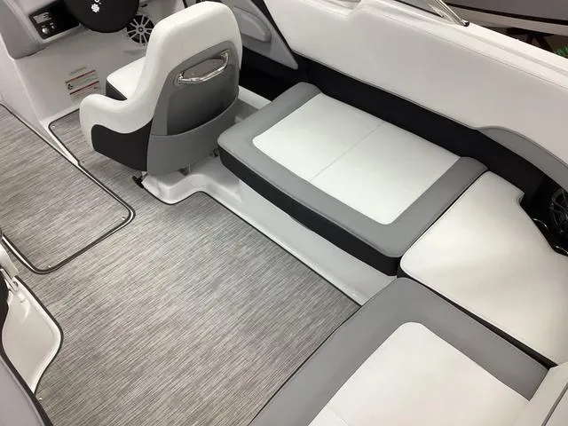 Slide: The Image of 2024 Cobalt 220S boat interior with sleek white and gray seating and modern design. - 16