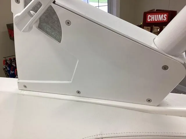 Slide: The Image of 2024 Cobalt 220S boat interior detail with white panel and "CHUMS" sign in background. - 6