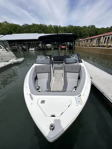 Slide: The Image of 2024 Cobalt CS23 boat docked at marina, featuring sleek design and modern seating. - 5