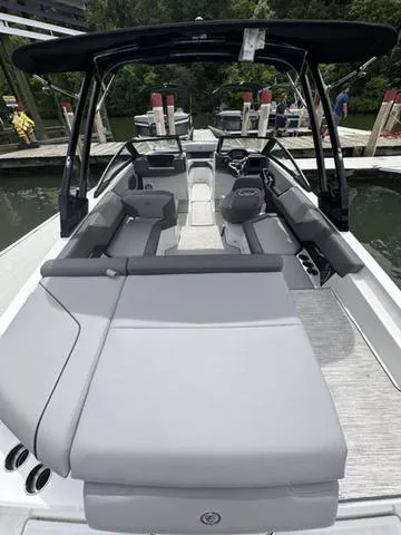 Slide: The Image of 2024 Cobalt CS23 boat with sleek seating and modern design at a dock. - 6