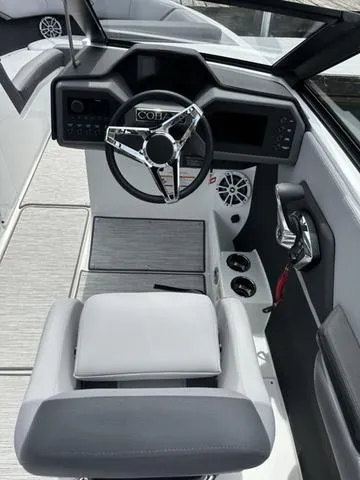Slide: The Image of 2024 Cobalt CS23 boat interior with sleek steering wheel and modern dashboard design. - 7