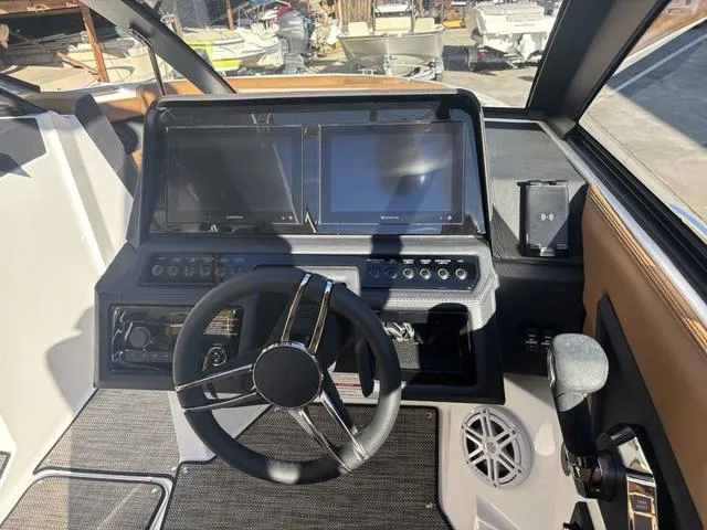 Slide: The Image of 2025 Cobalt R4 Surf boat dashboard with dual screens and steering wheel. - 10