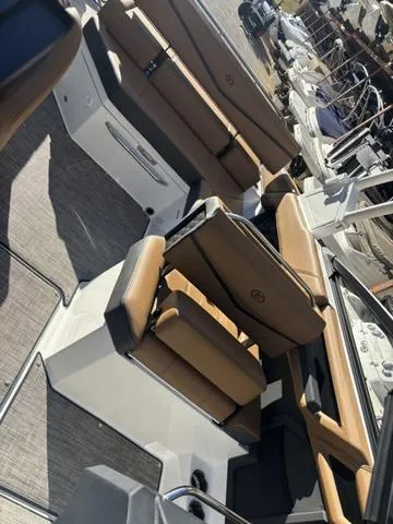 Slide: The Image of 2025 Cobalt R4 Surf boat interior with tan seating and modern design. - 12