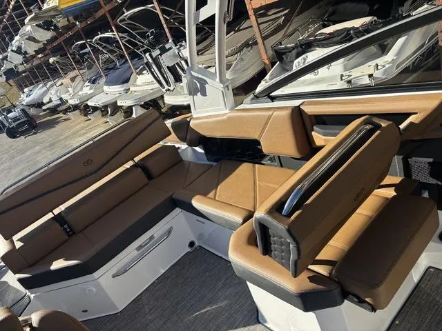 Slide: The Image of 2025 Cobalt R4 Surf boat interior with luxurious brown seating and modern design. - 13