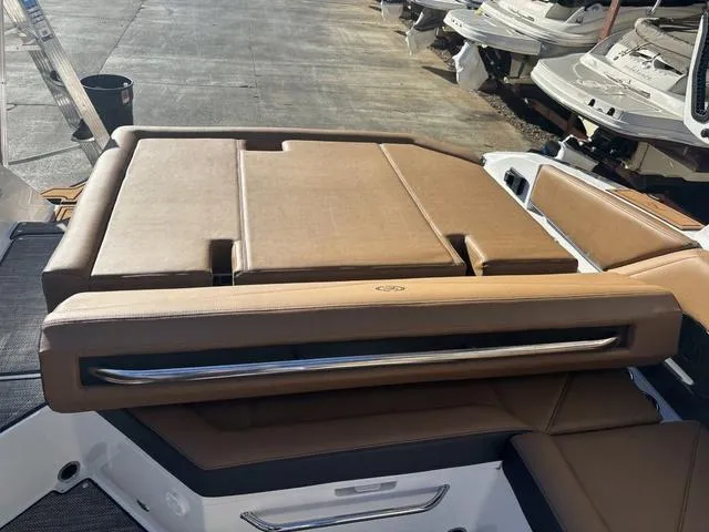 Slide: The Image of 2025 Cobalt R4 Surf boat with tan seating and sleek design. - 14