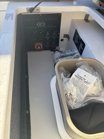 Slide: The Image of 2025 Cobalt R4 Surf boat interior with control panel and storage compartment. - 18