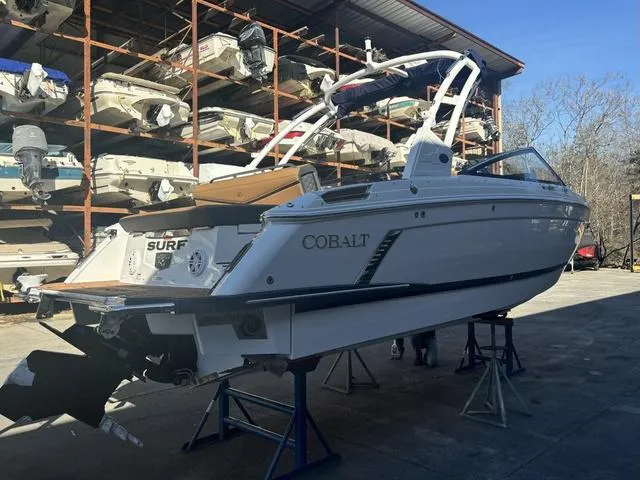 Slide: The Image of 2025 Cobalt R4 Surf boat on stands in a storage facility. - 2