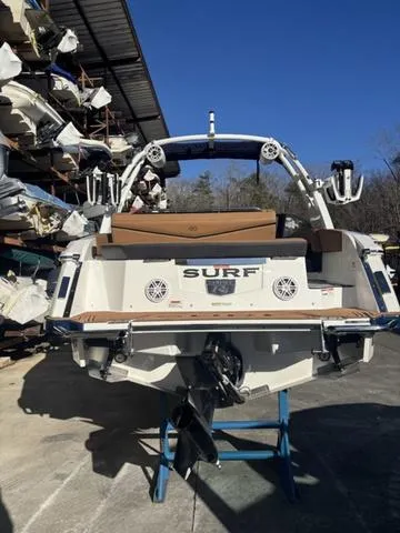 Slide: The Image of 2025 Cobalt R4 Surf boat in storage, rear view with clear blue sky. - 4