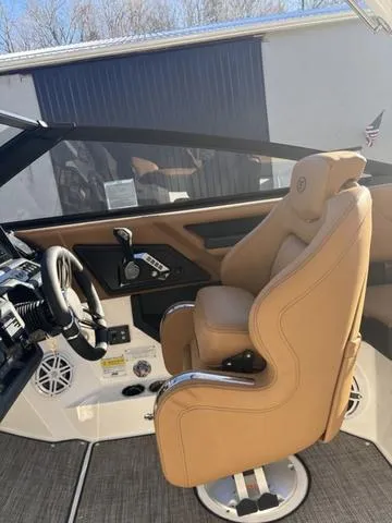 Slide: The Image of 2025 Cobalt R4 Surf boat interior with tan captain's seat and modern controls. - 8