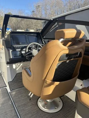 Slide: The Image of 2025 Cobalt R4 Surf boat interior with tan leather seating and modern dashboard. - 9