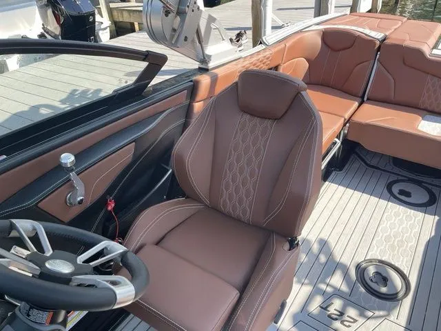 Slide: The Image of 2024 MasterCraft XT22 T boat interior with brown leather seats and modern design. - 12