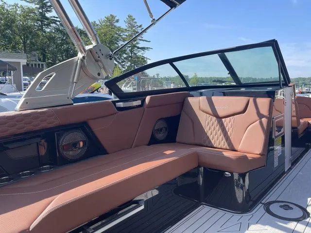 Slide: The Image of 2024 MasterCraft XT22 T boat interior with brown leather seating and modern design. - 5