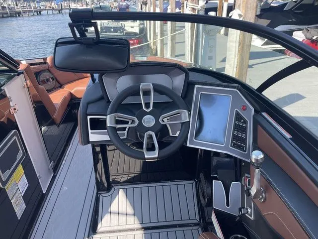 Slide: The Image of 2024 MasterCraft XT22 T boat cockpit with modern steering and touchscreen controls. - 7