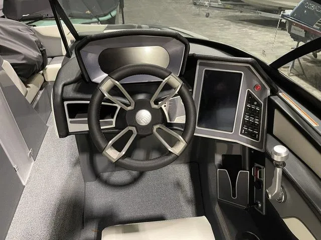 Slide: The Image of 2024 MasterCraft XT20 boat cockpit with modern steering wheel and digital controls. - 10