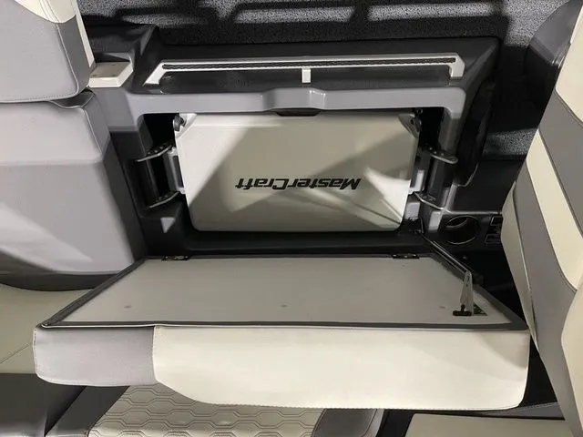 Slide: The Image of 2024 MasterCraft XT20 boat interior storage compartment with logo, featuring sleek design and functionality. - 14