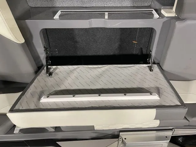 Slide: The Image of 2024 MasterCraft XT20 storage compartment with open lid, showcasing interior design and materials. - 15