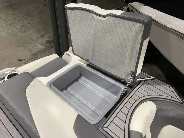 Slide: The Image of 2024 MasterCraft XT20 boat with open storage compartment, featuring gray and white interior. - 20