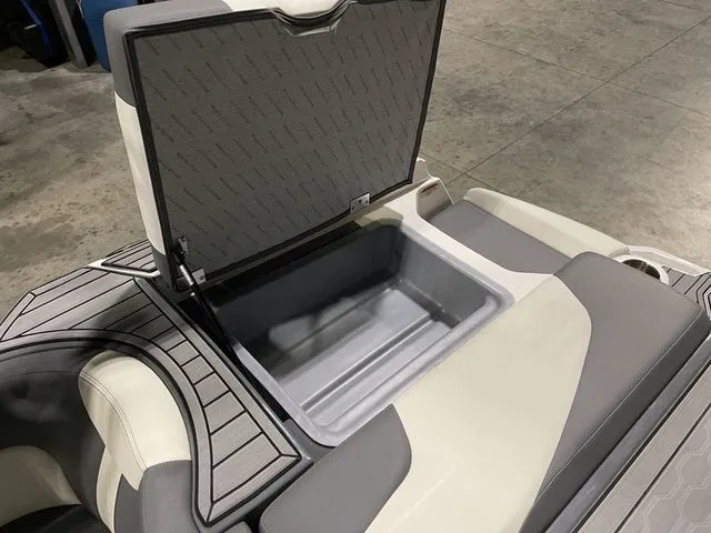 Slide: The Image of 2024 MasterCraft XT20 boat storage compartment with open lid, showcasing spacious interior. - 21