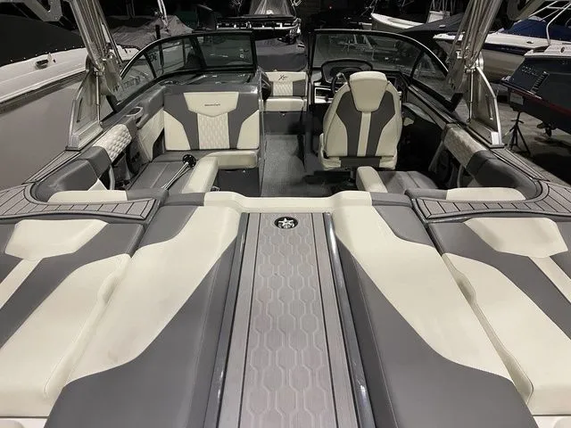 Slide: The Image of 2024 MasterCraft XT20 boat interior with modern seating and sleek design. - 8