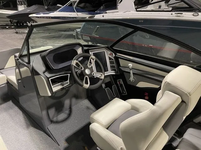 Slide: The Image of 2024 MasterCraft XT20 boat interior with modern steering and dashboard controls. - 9