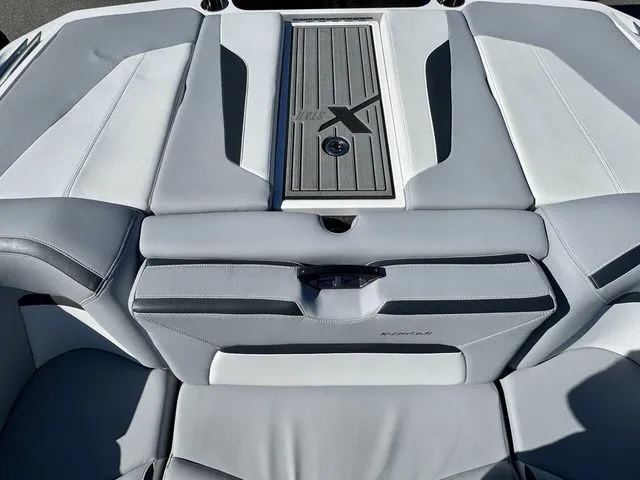 Slide: The Image of 2022 MasterCraft XStar boat interior with sleek gray seating and stylish design. - 11