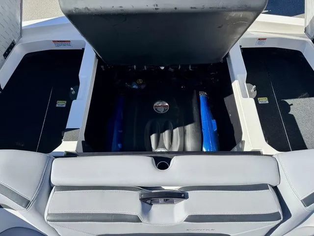 Slide: The Image of 2022 MasterCraft XStar boat engine compartment with open hatch, showcasing interior components. - 13