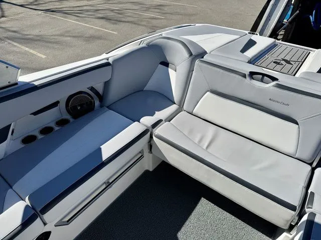 Slide: The Image of 2022 MasterCraft XStar boat interior with sleek gray seating and cup holders. - 16