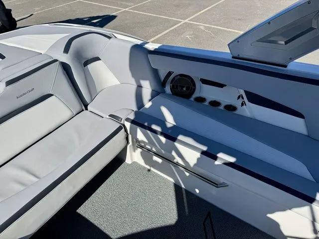 Slide: The Image of 2022 MasterCraft XStar boat interior with sleek seating and modern design. - 17