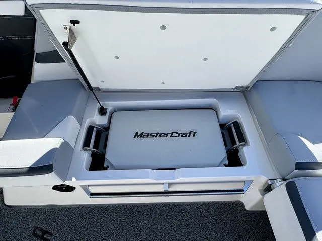 Slide: The Image of 2022 MasterCraft XStar boat storage compartment with branded cooler. - 20