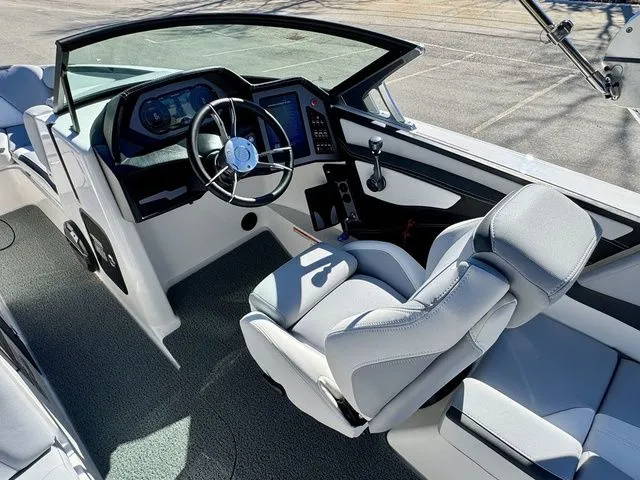 Slide: The Image of 2022 MasterCraft XStar boat interior with modern dashboard and comfortable seating. - 22