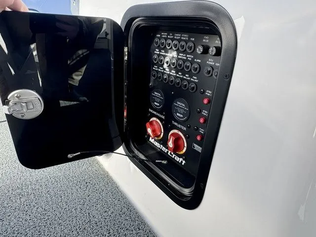 Slide: The Image of Control panel of a 2022 MasterCraft XStar boat with switches and dials. - 26