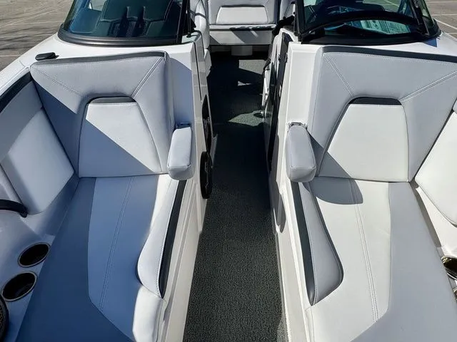 Slide: The Image of 2022 MasterCraft XStar boat interior with sleek white seating and modern design. - 28